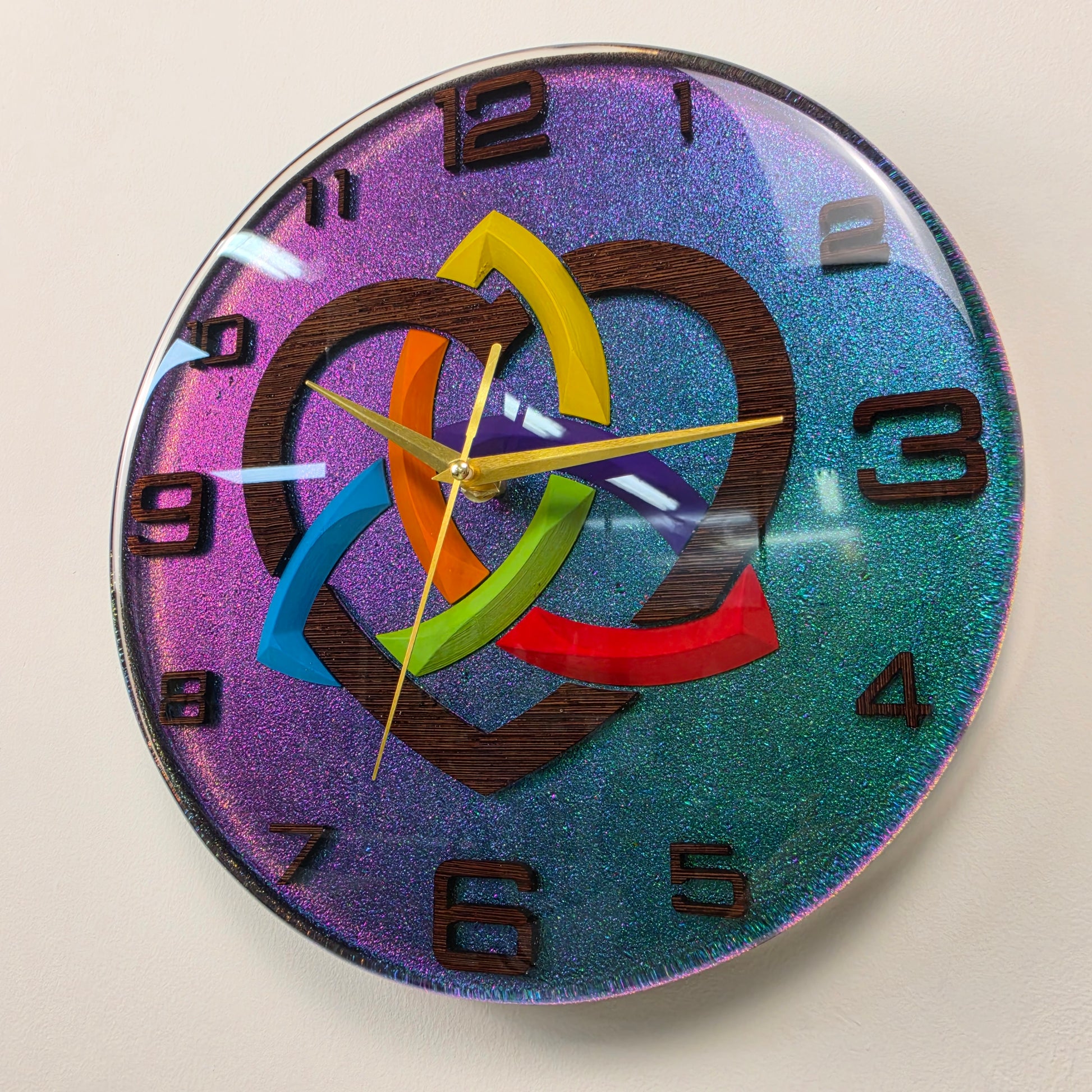 One-of-a-kind decorative resin clock featuring a Celtic-inspired Triquetra symbol V2, rainbow heart, chameleon background, and handcrafted wooden details.
