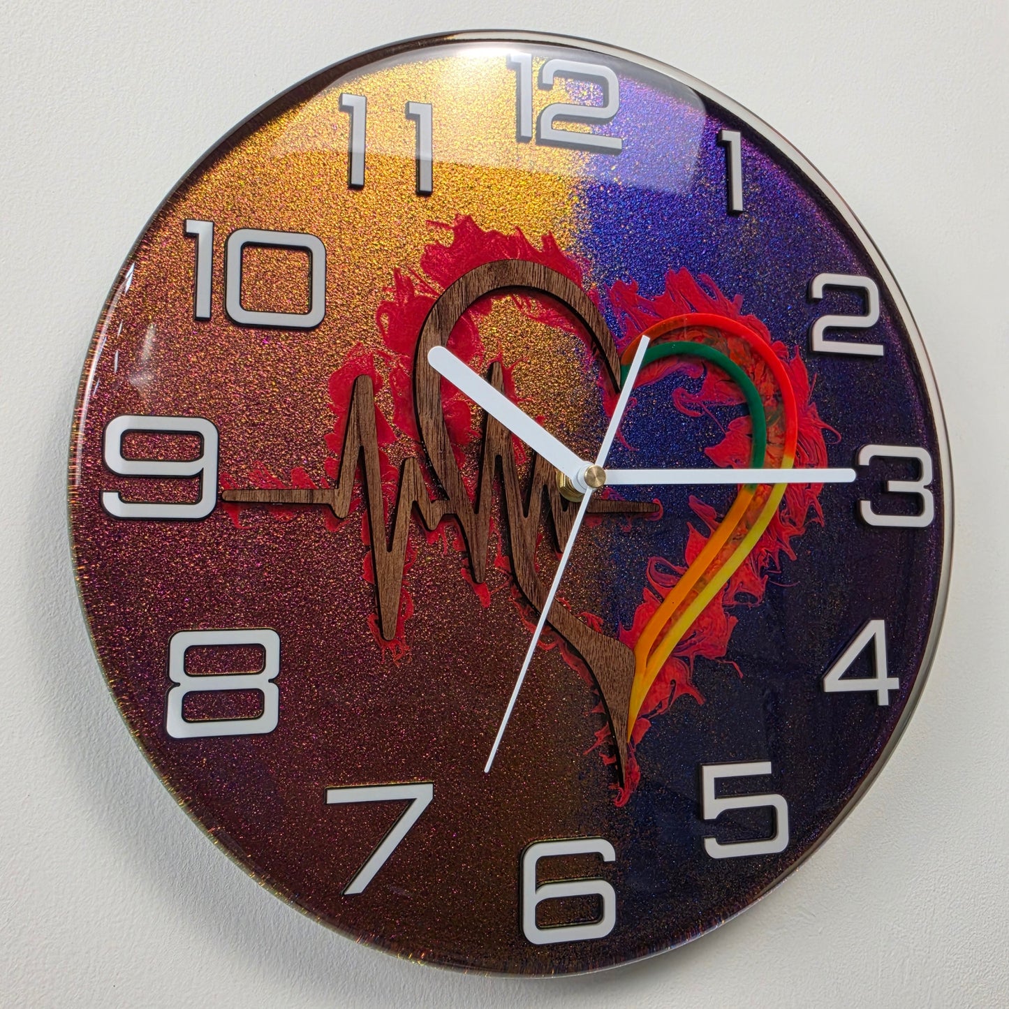 Heartbeat Within handmade resin wall clock with black walnut heart, ECG line and color-shifting chameleon background.