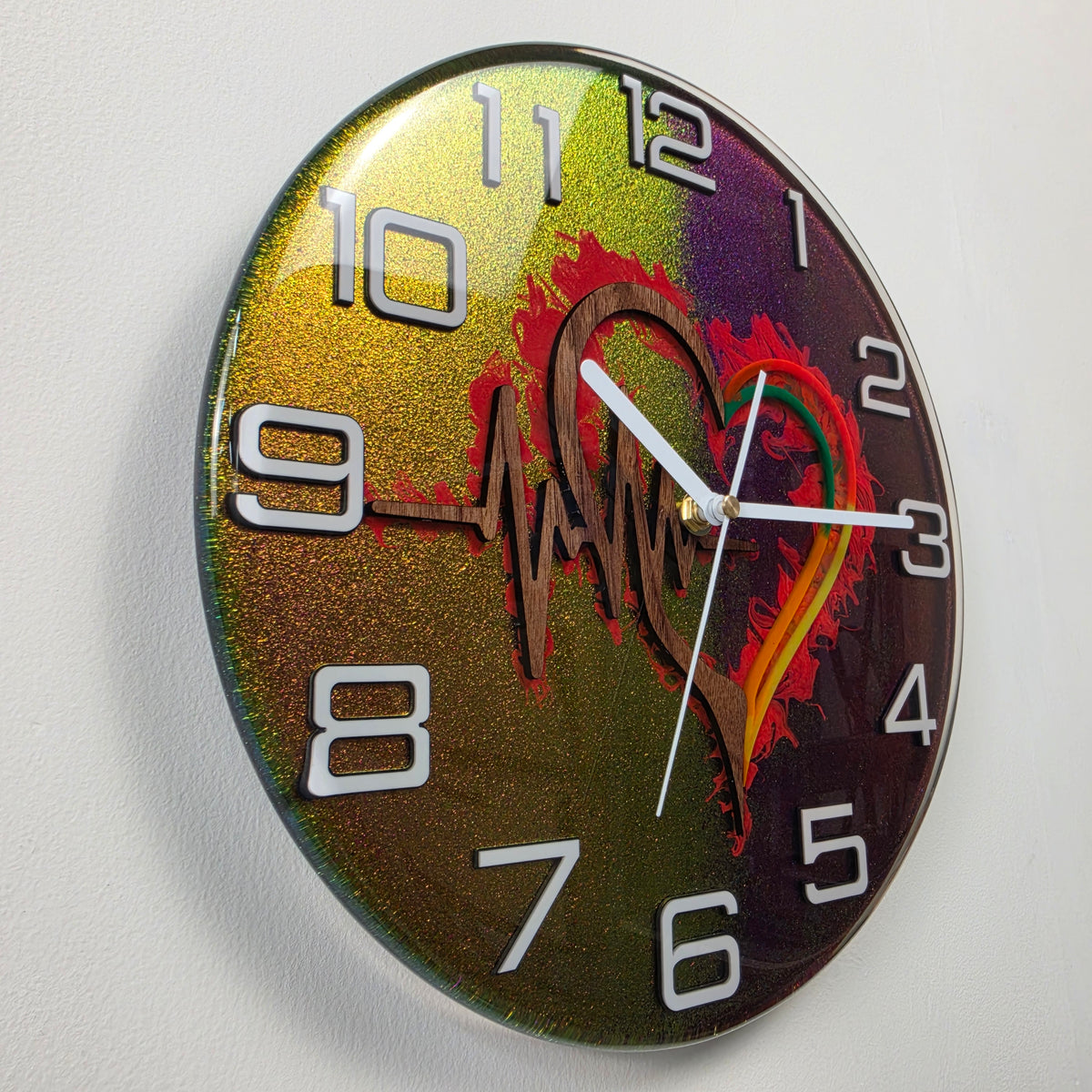 Modern resin wall clock with black walnut heart and heartbeat line set against a shimmering color-changing background.