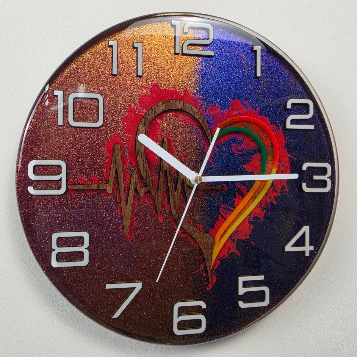 Color-shifting handmade wall clock from the Timeless Symbols collection with black walnut heart and heartbeat artwork.