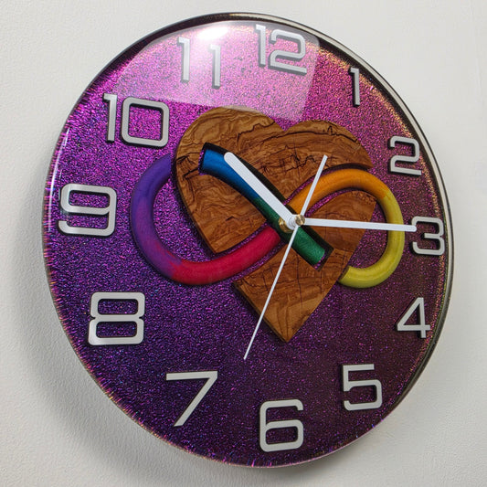Handmade resin wall clock with an olive wood heart, colorful infinity symbol and shimmering chameleon background.