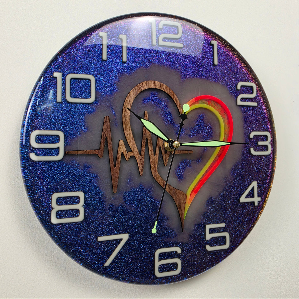 Timeless Symbols Pulse of Life handmade wall clock with Black Walnut heart, ECG line and chameleon resin background.
