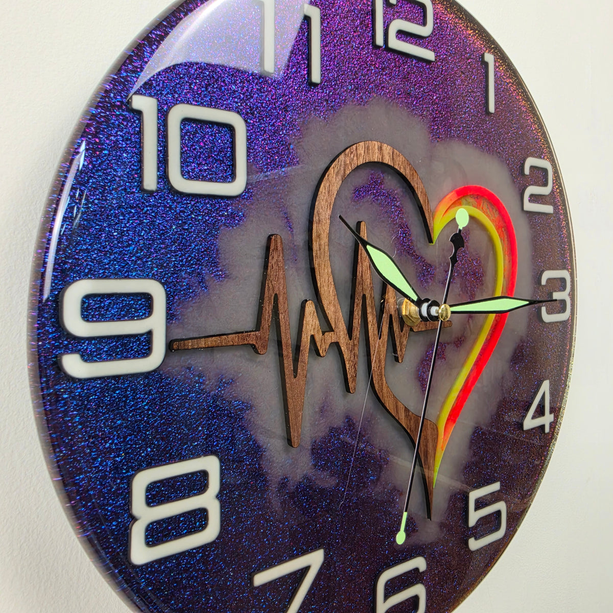 Pulse of Life artistic wall clock with wooden heart, ECG heartbeat symbol and glowing numerals.