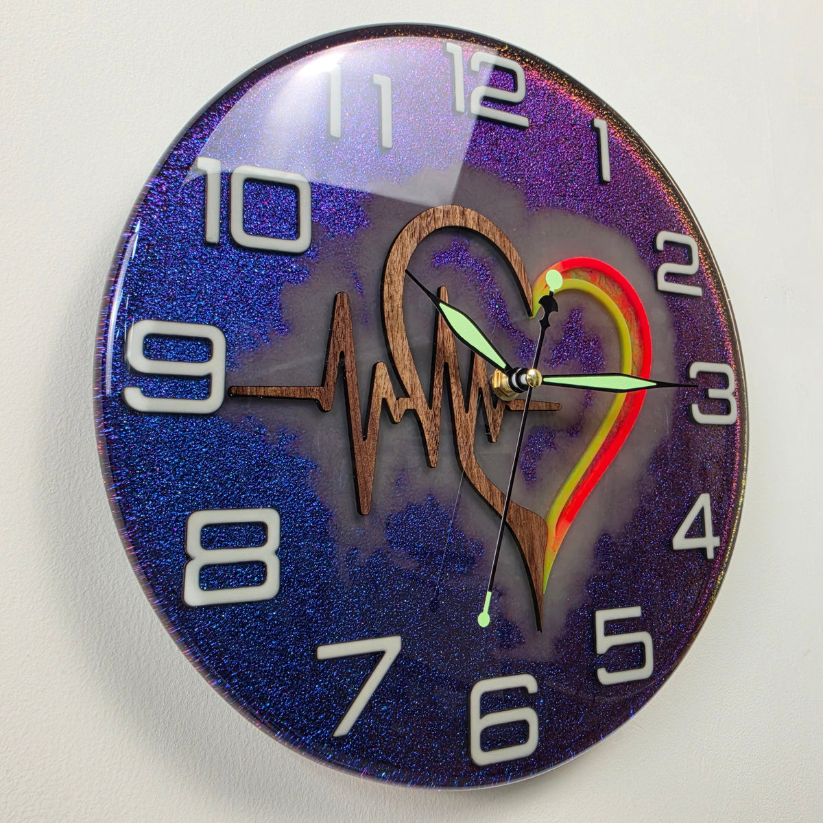 Unique 30 cm wall clock combining Black Walnut wood, chameleon colors and fluorescent glow-in-the-dark details.