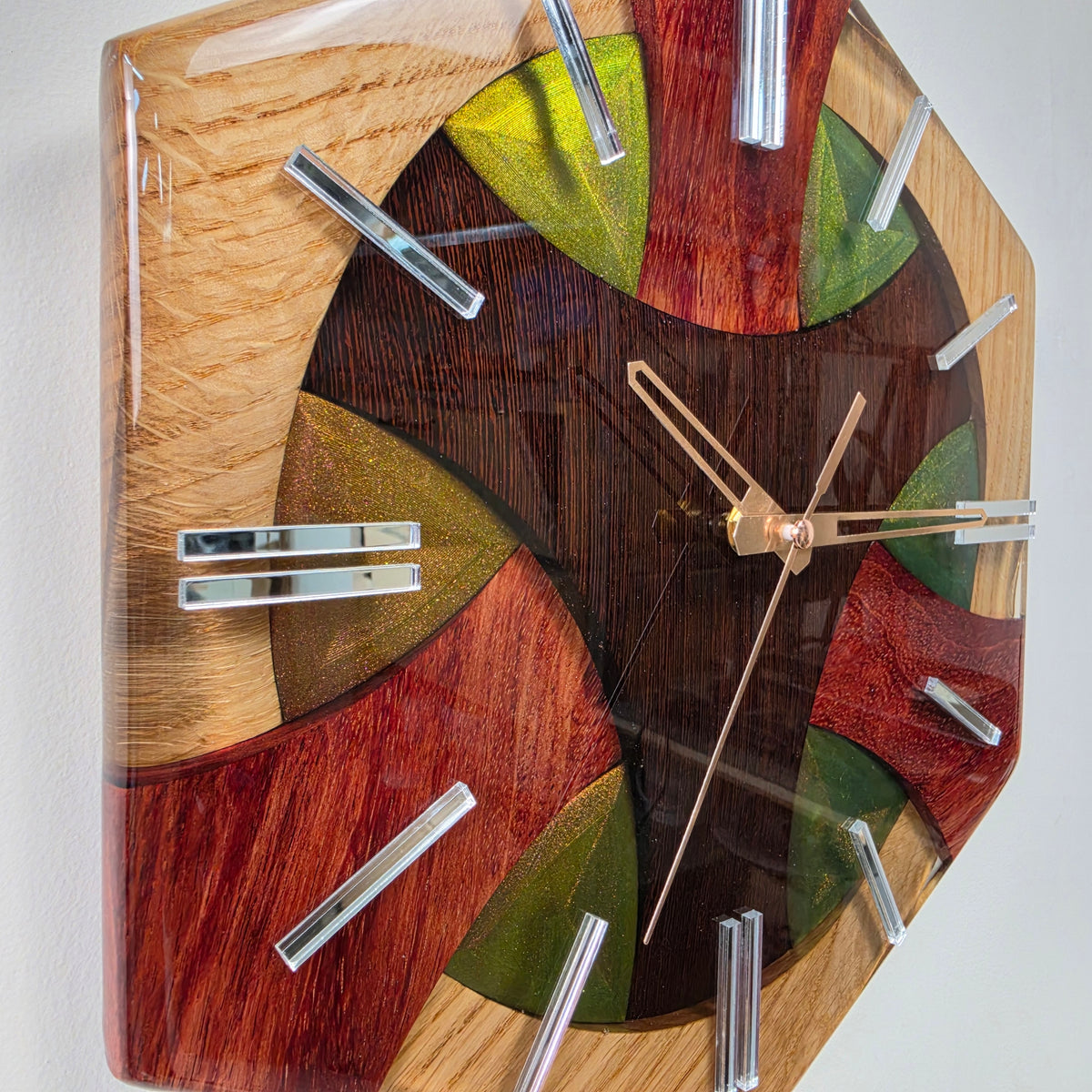 Wood Line Three Elements wall clock featuring oak, dark wenge and reddish bubinga encapsulated in clear resin.