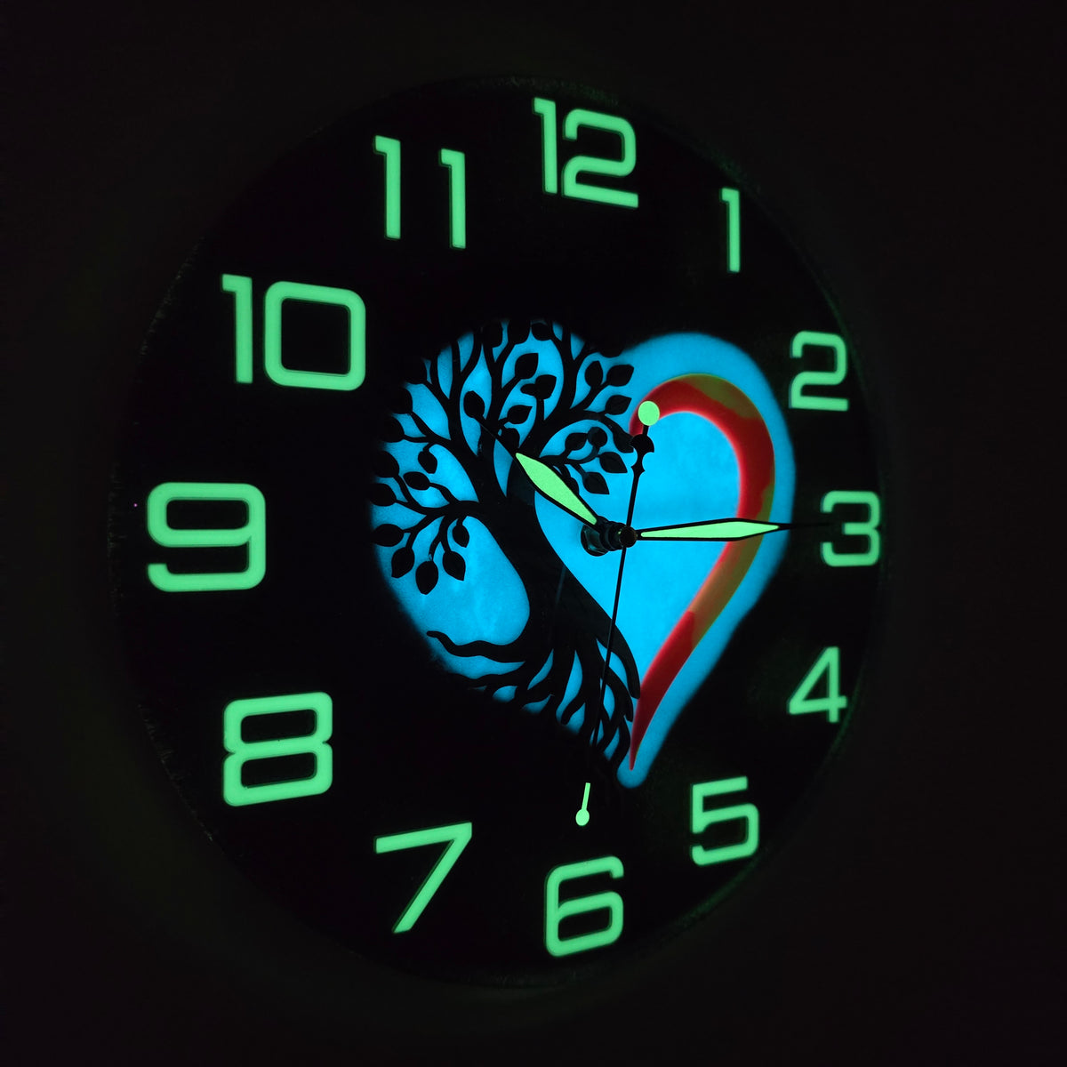 One-of-a-kind Tree of Life and heart wall clock transforming from colorful chameleon art by day to glowing functional art at night.