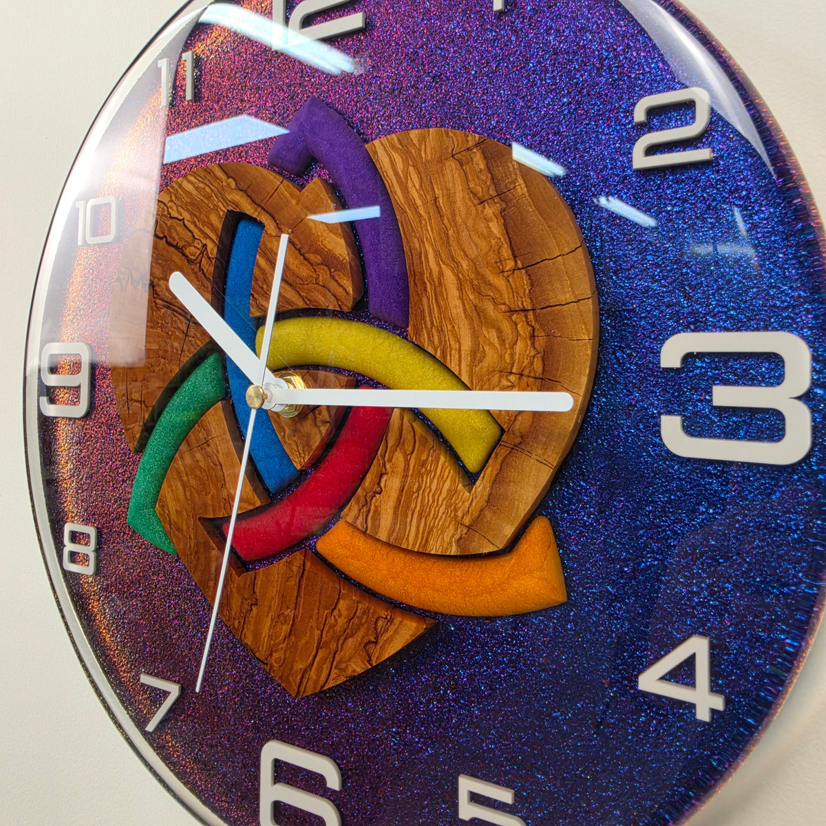 Handcrafted resin wall clock with olive wood, multicolor heart design and color-shifting chameleon effect.