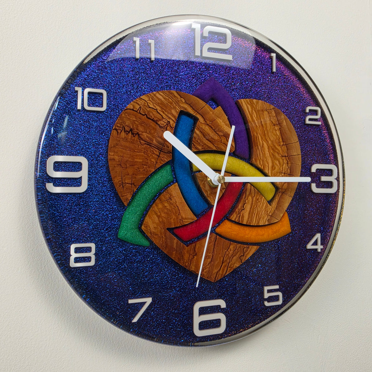 Timeless Symbols Woven Heart wall clock with olive wood, colorful interwoven heart and chameleon resin background.