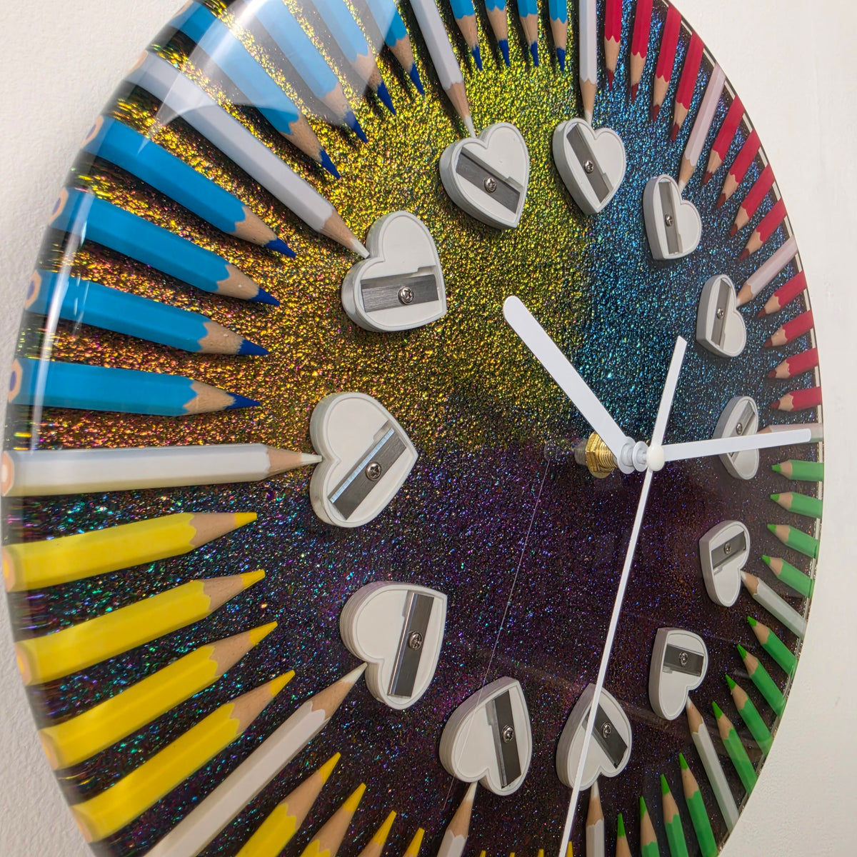 Studio Colors Four Seasons artistic resin clock featuring colorful pencils arranged in four seasonal color sections.