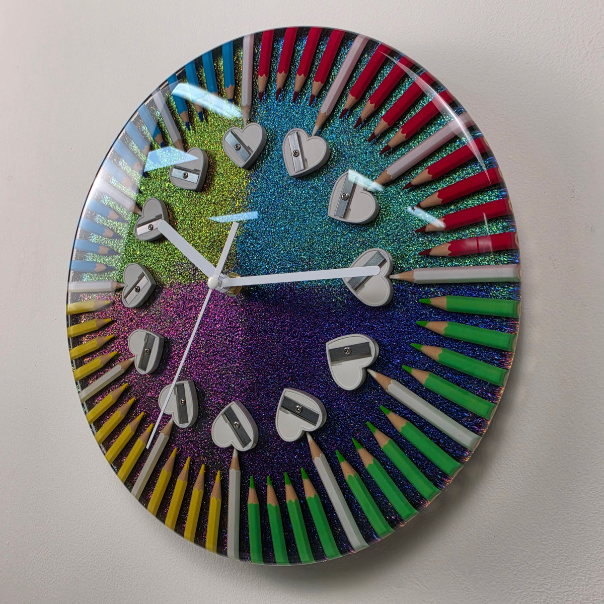 Unique handmade epoxy resin wall clock with colored pencils, heart-shaped sharpeners and a color-shifting chameleon background.