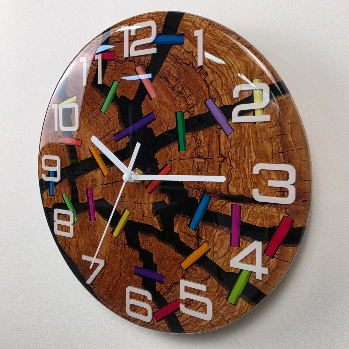 Handcrafted resin wall clock featuring cracked olive wood, colorful pencils and white Plexiglas numerals.