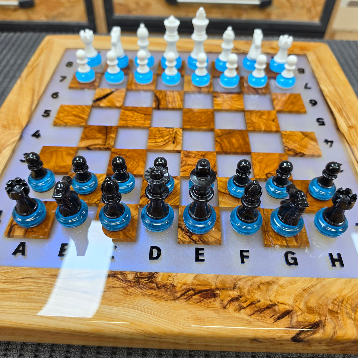 LED chessboard with olive wood frame, epoxy resin and illuminated playing surface