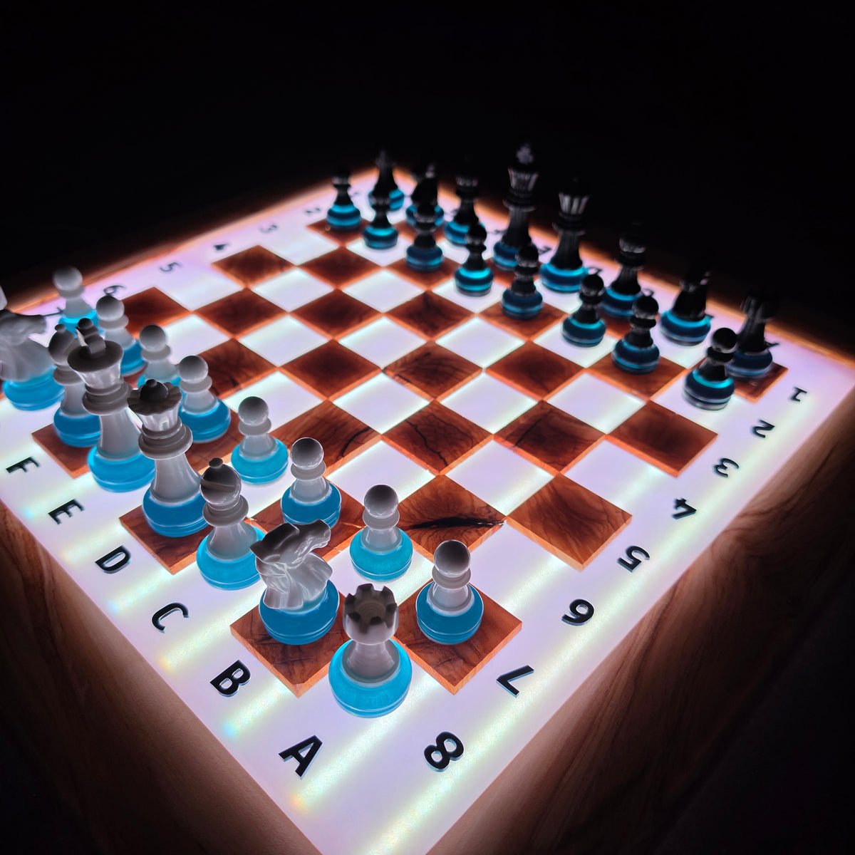 Modern illuminated chessboard combining natural olive wood, resin and LED technology