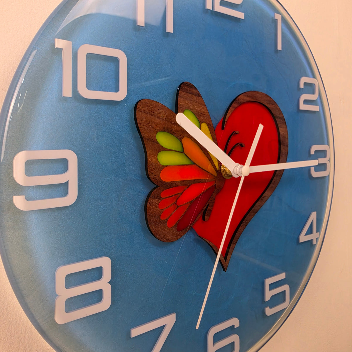 Timeless Symbols Wings of Love 30 cm wall clock handcrafted from natural wood and epoxy resin.