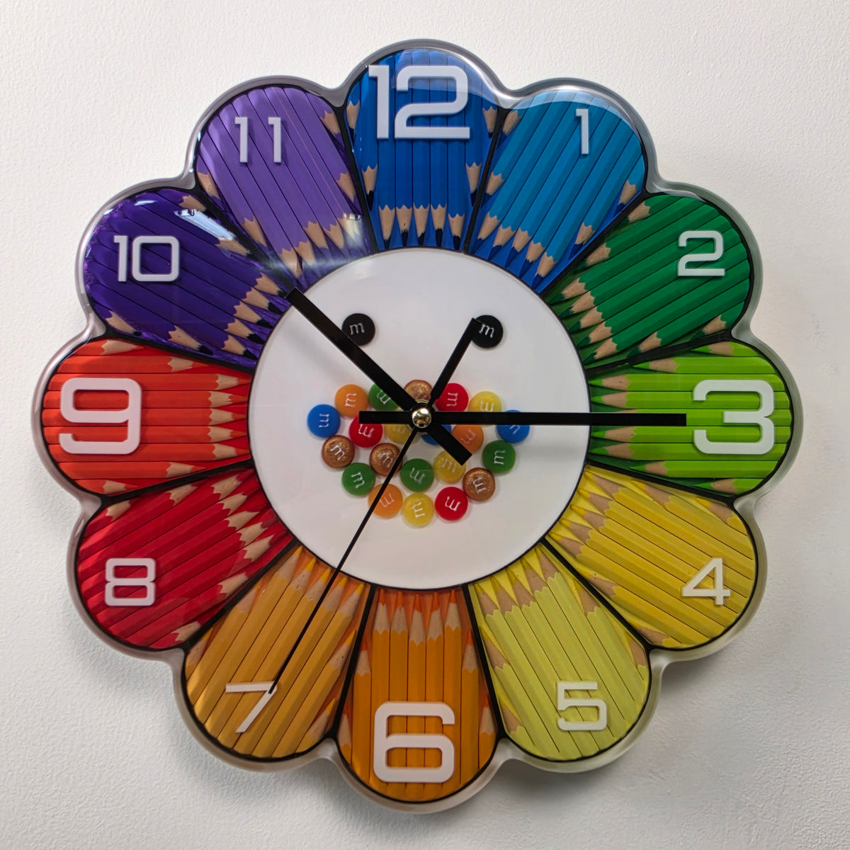 Rainbow Bloom Numbers handmade flower-shaped wall clock with colorful pencils, white numbers and glossy epoxy resin.