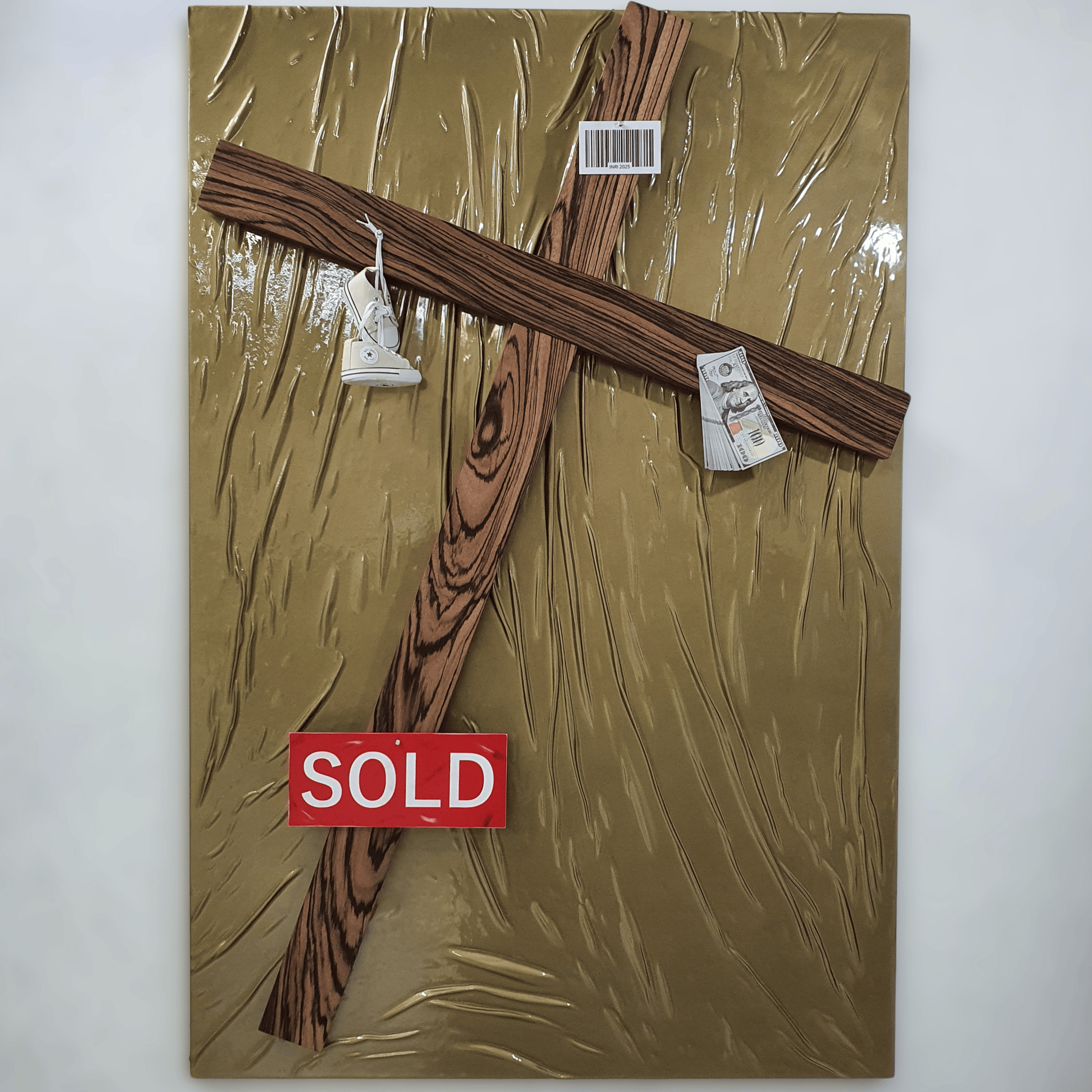 Il Settimo Comandamento conceptual artwork – wooden cross with baby shoes, money, barcode and red SOLD sign, front view