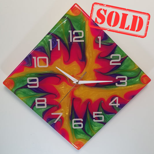 Front view of the “Electric Whirl” epoxy resin wall clock – diamond-shaped with bold, swirling colors