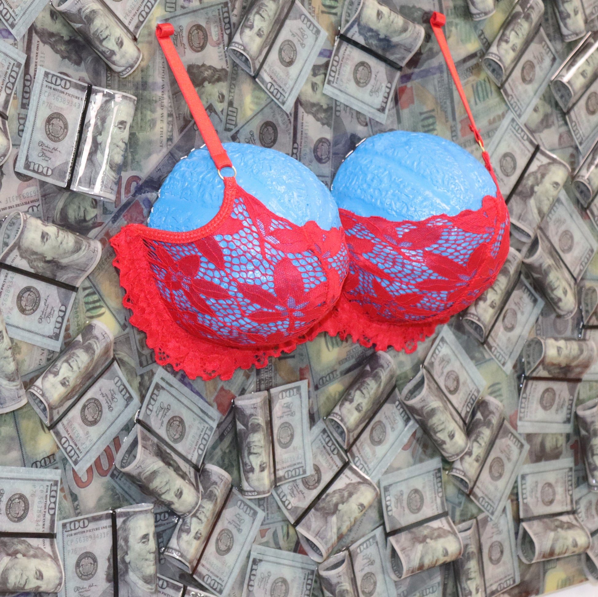 Mondo Blu resin and plaster conceptual artwork – detail close-up with blue busts, red bra and dollar background