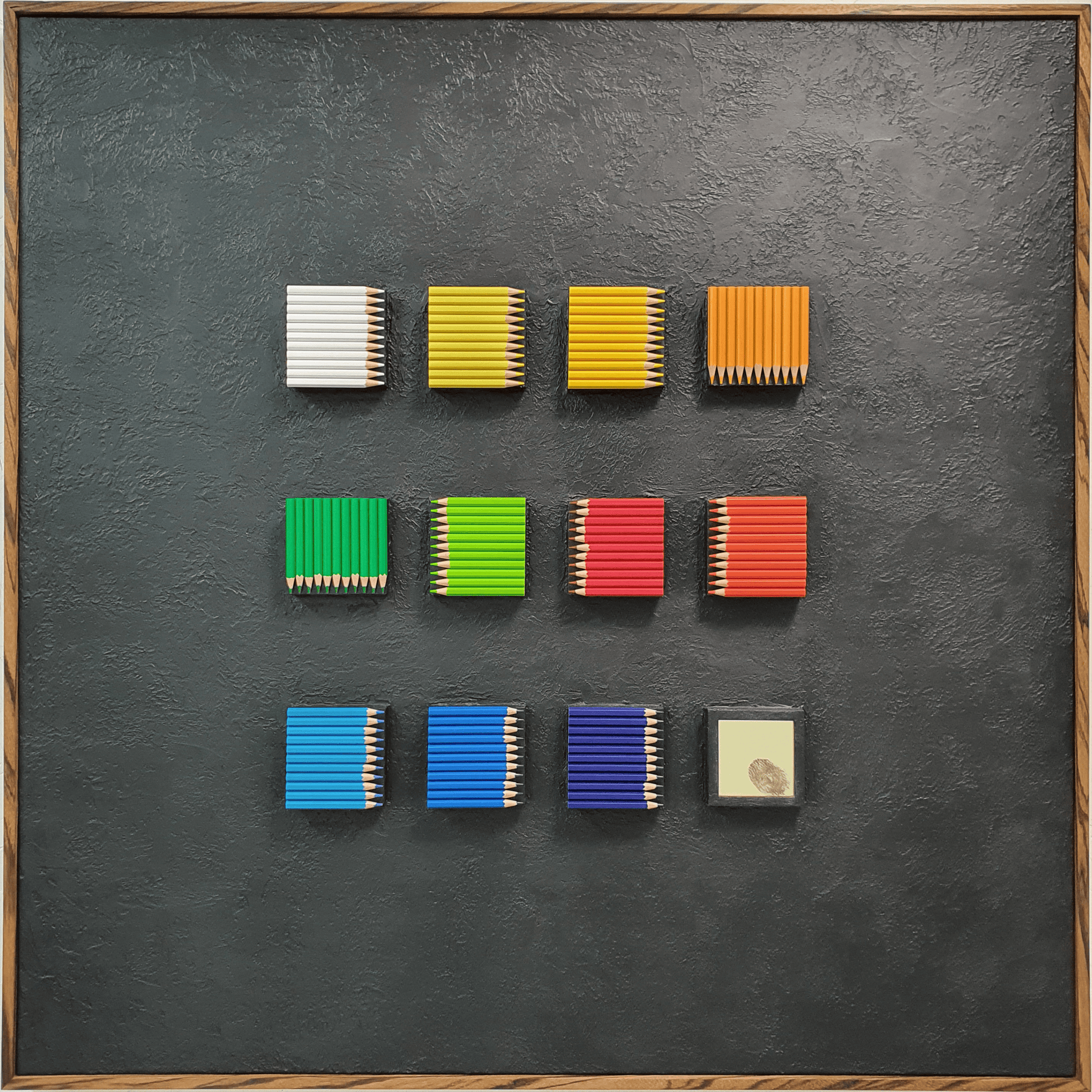 Identità Ordinata conceptual artwork – twelve colorful resin pencil blocks with golden mirror fingerprint, front view