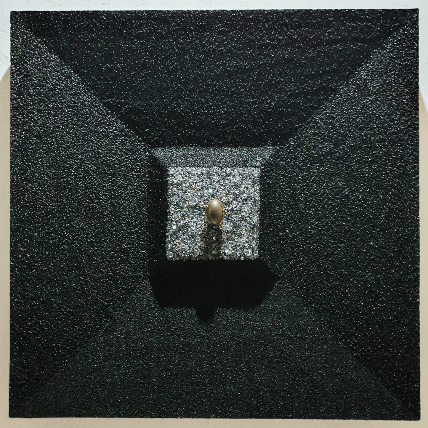 La Verità Nascosta conceptual artwork – golden egg emerging from block of crystals framed in dark structure, front view