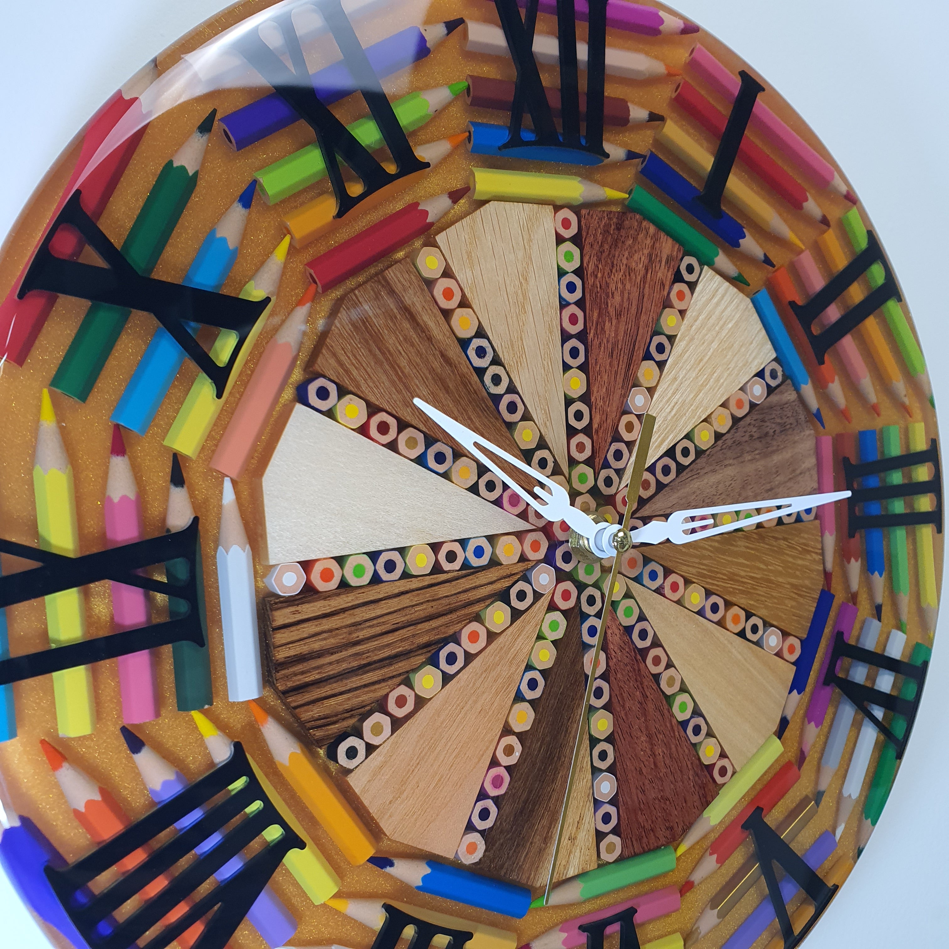 Close-up side angle of the "Timber Pop" clock – detailed wood segments and embedded colored pencils under glossy resin